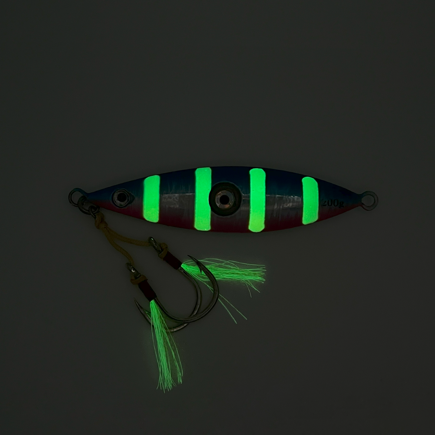 Candy lure showing phosphorescent white stripes and skirts glowing in the dark.