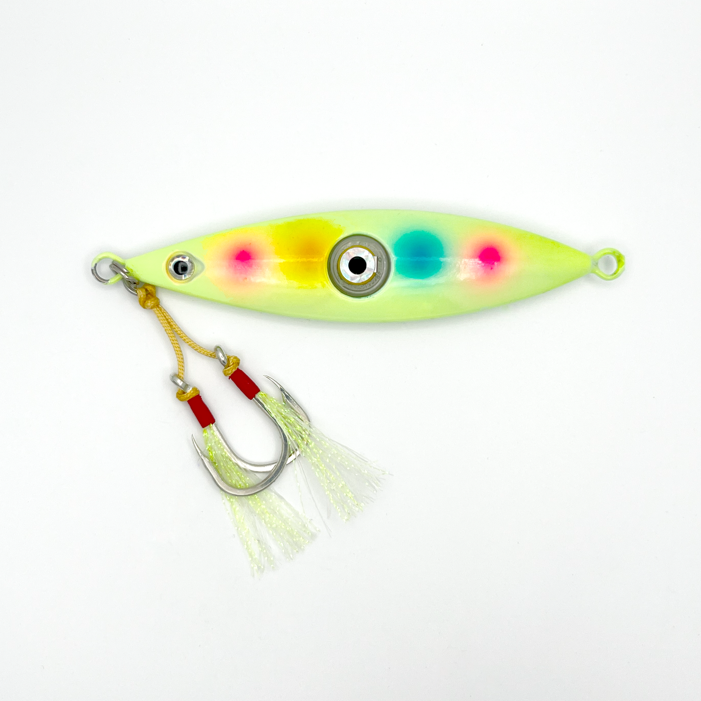 Multi-Color Dots lure. Light yellow/green lure with pink, yellow, and teal dots horizontally across the middle, two hooks with reflective skirts, and light-up eye in the center.