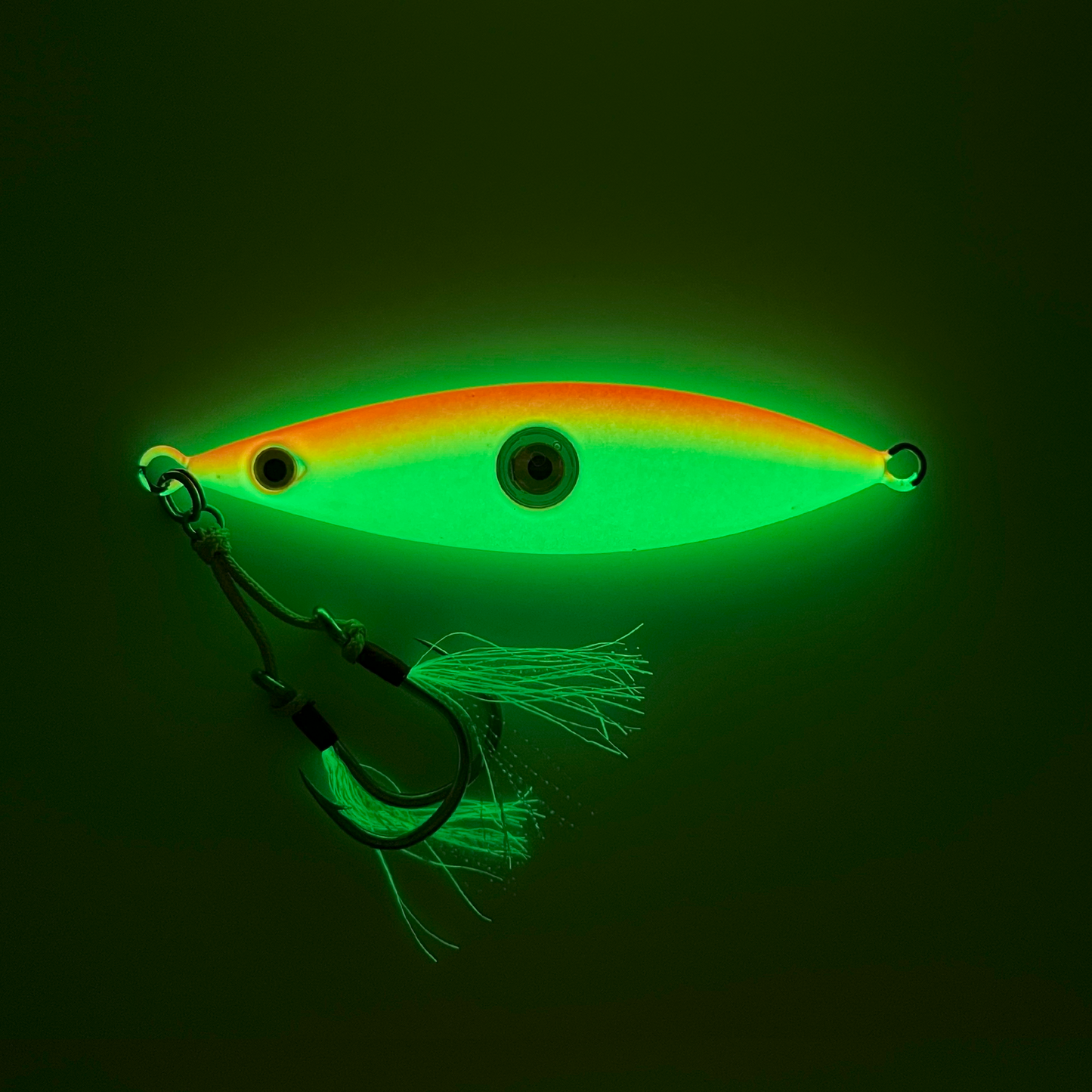 Sunset lure showing full phosphorescent paint and skirts glowing in the dark.