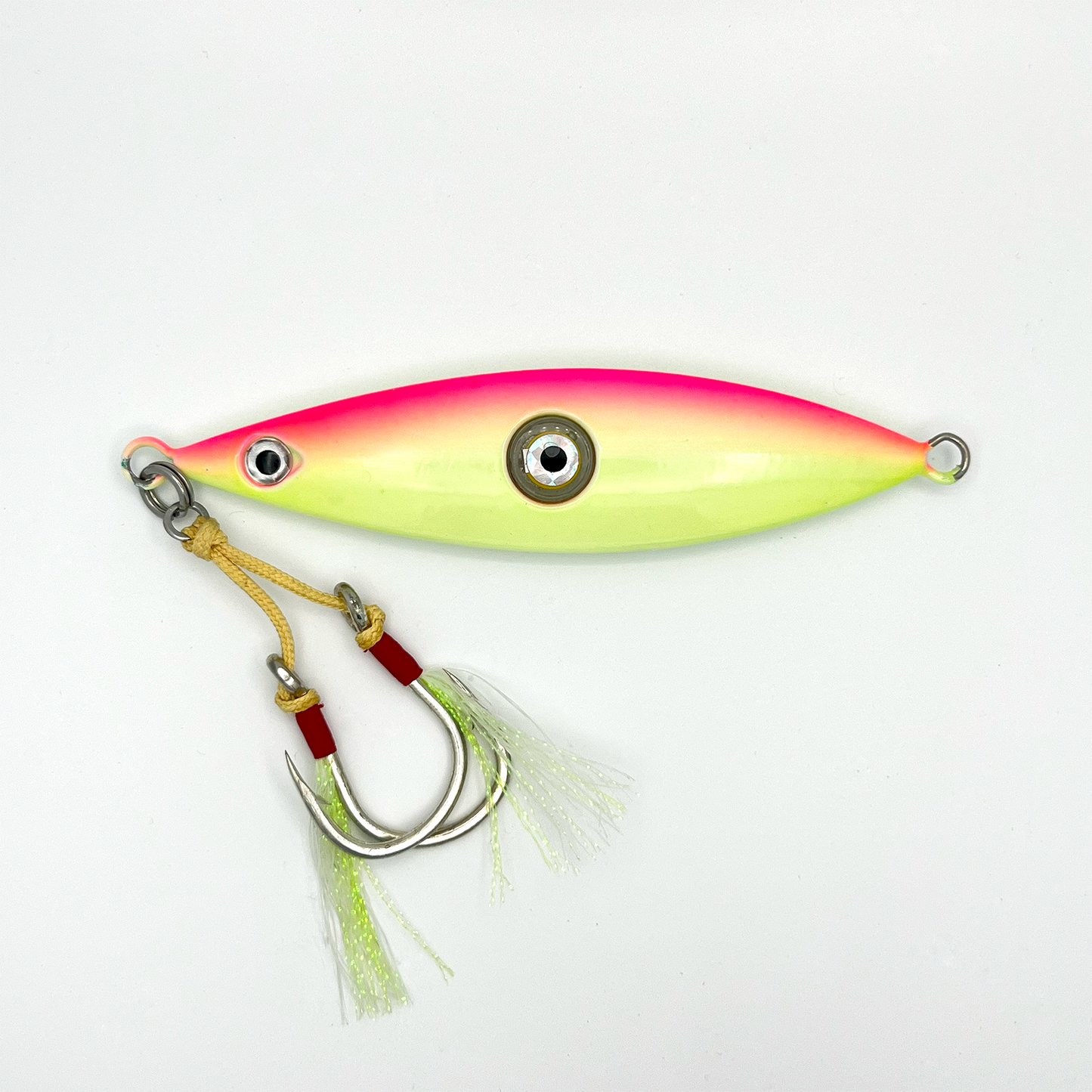 Sunset lure. Light yellow/green lure with pink horizontal stripe on top and two hooks with reflective skirts.